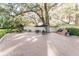Outdoor patio area with brick pavers, patio furniture, umbrellas, and a built-in grill for outdoor dining at 604 Chestnut Oak Cir # 106, Altamonte Springs, FL 32701