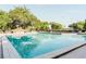 Community pool surrounded by lush greenery and a wrought iron fence at 604 Chestnut Oak Cir # 106, Altamonte Springs, FL 32701