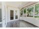 Screened porch with tile flooring, white frame and patio door access to the outside at 604 Chestnut Oak Cir # 106, Altamonte Springs, FL 32701