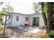 Backyard patio, partially fenced, with a grill and an exterior door at 704 Beverly Ave, Altamonte Springs, FL 32701