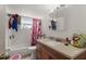 Cozy bathroom featuring a vanity sink, framed mirror, bathtub and patterned shower curtain at 707 Michigan Ct # 2, St Cloud, FL 34769