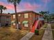 Charming two-story home featuring beautiful stucco siding, complemented by lush landscaping, and a inviting stairway at 707 Michigan Ct # 2, St Cloud, FL 34769