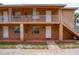 Attractive two-story exterior showcasing upper-level patio and stairs to the lower level at 707 Michigan Ct # 2, St Cloud, FL 34769