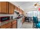 Functional kitchen featuring granite countertops, wood cabinets, and modern appliances including a electric cooktop at 707 Michigan Ct # 2, St Cloud, FL 34769