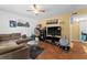 Cozy living room featuring a comfortable brown sofa, stylish decor, and wood laminate flooring at 707 Michigan Ct # 2, St Cloud, FL 34769