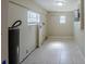 Clean basement area featuring tile flooring, bright lighting and utility hookups at 72 Campus View Dr, Orlando, FL 32810