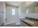 Bright bathroom features white tiled walls, tub/shower combo, granite countertop on vanity, and window for natural light at 72 Campus View Dr, Orlando, FL 32810