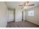 Carpeted bedroom featuring a closet, ceiling fan, neutral walls, and a window for natural light at 72 Campus View Dr, Orlando, FL 32810