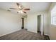 Spacious bedroom with ceiling fan, closet, wood-look flooring, and windows for natural light at 72 Campus View Dr, Orlando, FL 32810