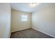 Cozy bedroom space featuring neutral walls and carpet with a bright window at 72 Campus View Dr, Orlando, FL 32810