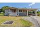 Charming single-story home featuring a carport, front porch, and well-maintained lawn at 72 Campus View Dr, Orlando, FL 32810