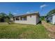 Single story home with an extended front porch, concrete construction, and a green lawn at 72 Campus View Dr, Orlando, FL 32810