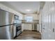 Updated kitchen featuring stainless steel appliances, white cabinets, and modern flooring at 72 Campus View Dr, Orlando, FL 32810