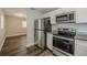 A modern kitchen featuring stainless appliances and sleek granite countertops at 72 Campus View Dr, Orlando, FL 32810