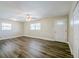 Bright living room features wood-look floors, a ceiling fan, and windows for natural light at 72 Campus View Dr, Orlando, FL 32810