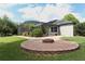 Beautiful backyard with a brick fire pit and a screened-in lanai, perfect for entertaining at 753 Grey Heron Pl, Chuluota, FL 32766