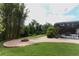Spacious backyard featuring a brick fire pit and lush green lawn, perfect for outdoor enjoyment at 753 Grey Heron Pl, Chuluota, FL 32766