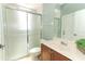 Bathroom featuring glass shower door, white commode, and a neutral vanity and countertop at 753 Grey Heron Pl, Chuluota, FL 32766