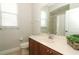 Bathroom vanity with a sink, wooden cabinets, and a mirror with a view of the walk-in shower at 753 Grey Heron Pl, Chuluota, FL 32766