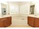 Bathroom with double vanities, garden tub and mirrors at 753 Grey Heron Pl, Chuluota, FL 32766