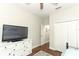 Bedroom featuring wood floors and a dresser with a tv at 753 Grey Heron Pl, Chuluota, FL 32766