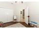 Neutral bedroom features closet, play easel, and view into an adjacent living space at 753 Grey Heron Pl, Chuluota, FL 32766