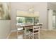 Light-filled dining area with large window overlooking the backyard and pool at 753 Grey Heron Pl, Chuluota, FL 32766