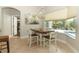 Dining area features a chandelier and sliding doors with view of outdoor pool at 753 Grey Heron Pl, Chuluota, FL 32766