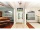 Inviting foyer with tile flooring, a decorative glass door, and views into adjacent living spaces at 753 Grey Heron Pl, Chuluota, FL 32766