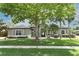 Charming single-story home featuring a beautifully landscaped front yard with a large tree for shade at 753 Grey Heron Pl, Chuluota, FL 32766