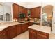 Traditional-style kitchen with wood cabinetry, tile backsplash, and stainless steel microwave at 753 Grey Heron Pl, Chuluota, FL 32766