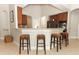 Open kitchen area with bar seating, tiled floors, and stainless steel appliances at 753 Grey Heron Pl, Chuluota, FL 32766