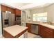 Bright kitchen with stainless steel appliances, breakfast bar, and double ovens at 753 Grey Heron Pl, Chuluota, FL 32766