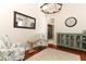 Cozy living area featuring stylish chairs, a decorative cabinet, and wood flooring at 753 Grey Heron Pl, Chuluota, FL 32766