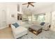 Open-concept living room featuring a large sectional sofa and views of the kitchen and dining area at 753 Grey Heron Pl, Chuluota, FL 32766