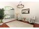 Comfortable living room with a large window, stylish chairs, and a decorative chandelier at 753 Grey Heron Pl, Chuluota, FL 32766