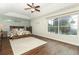 Spacious main bedroom with a ceiling fan, wood flooring, and a large window overlooking a screened-in patio at 753 Grey Heron Pl, Chuluota, FL 32766