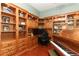 Spacious office featuring custom cabinetry, built-in shelving, and a workspace with natural light at 753 Grey Heron Pl, Chuluota, FL 32766