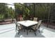 Screened-in lanai with a dining table and four chairs surrounded by lush tropical plants at 753 Grey Heron Pl, Chuluota, FL 32766