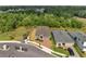 Beautiful aerial showcasing a landscaped single-Gathering home next to a large greenbelt in a quiet suburban neighborhood at 7651 Five Oaks Dr, Harmony, FL 34773