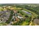 Gorgeous aerial view of the community amenities including a clubhouse, pool, tennis courts and golf course surrounded by beautiful lakes at 7651 Five Oaks Dr, Harmony, FL 34773