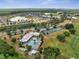 Overhead aerial of the community pool, tennis courts, parking and golf course in a luxurious, landscaped neighborhood at 7651 Five Oaks Dr, Harmony, FL 34773