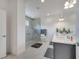 Bright bathroom features a walk-in shower with seat, double vanity and grey accents at 7651 Five Oaks Dr, Harmony, FL 34773
