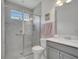 Modern bathroom features a glass-enclosed shower, vanity with sink, and stylish tiled walls at 7651 Five Oaks Dr, Harmony, FL 34773