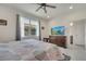 Inviting bedroom with large window, ceiling fan, and bathroom access at 7651 Five Oaks Dr, Harmony, FL 34773