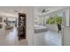 Bright bedroom with large window, ensuite access, and modern decor at 7651 Five Oaks Dr, Harmony, FL 34773