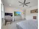 Comfortable bedroom with TV, ceiling fan, and soft natural light at 7651 Five Oaks Dr, Harmony, FL 34773