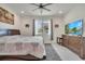 Well-lit bedroom with a ceiling fan, neutral walls, and comfortable bed at 7651 Five Oaks Dr, Harmony, FL 34773