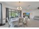 The dining room features a chandelier and sliding glass doors to the outdoors at 7651 Five Oaks Dr, Harmony, FL 34773