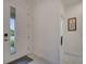 Bright entryway with a glass-paneled door, neutral walls, and tiled flooring leading into the home at 7651 Five Oaks Dr, Harmony, FL 34773